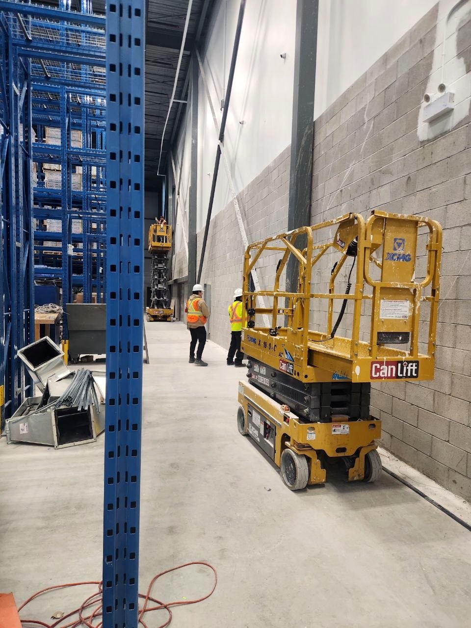 Large warehouse interior with lift equipment